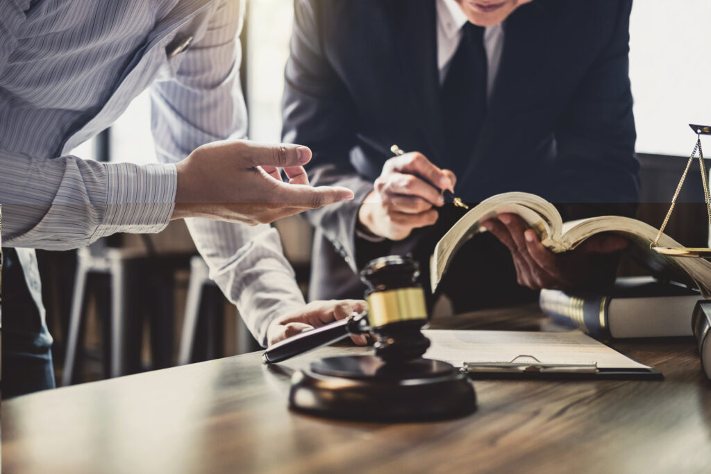 Lawyers working around a Gavel on a table