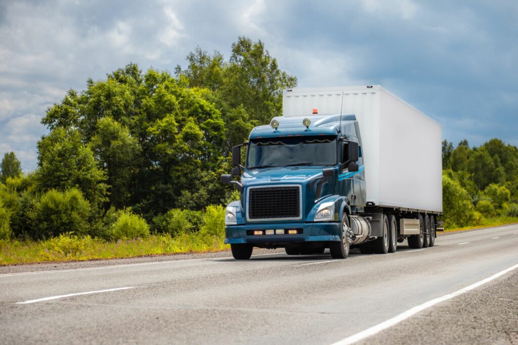 Large truck driving down the road