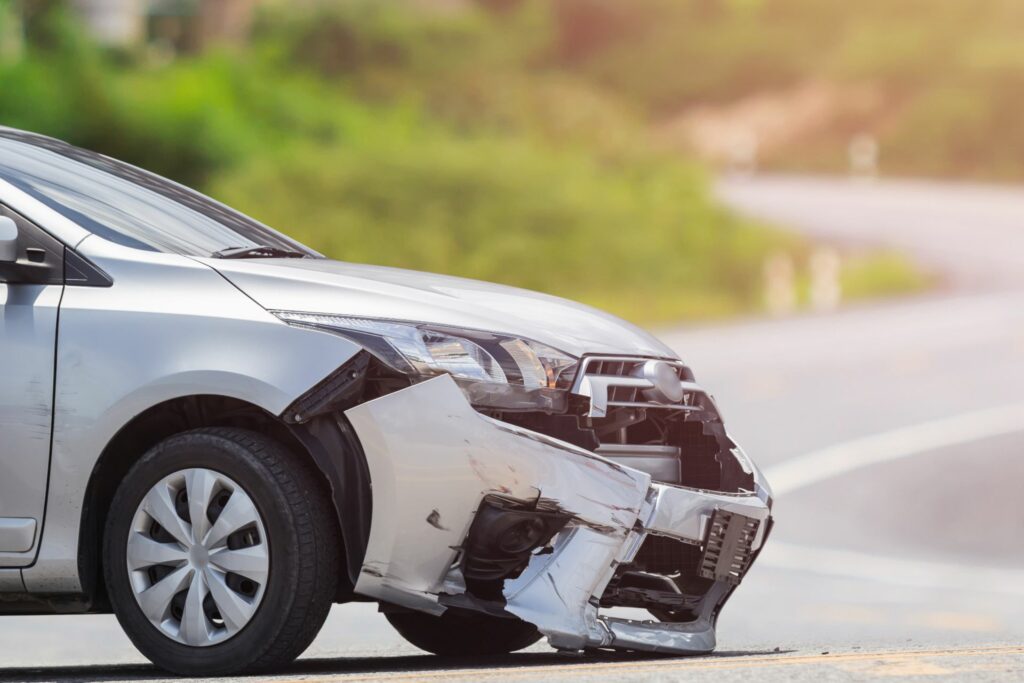 Car on the road with a damaged bumper