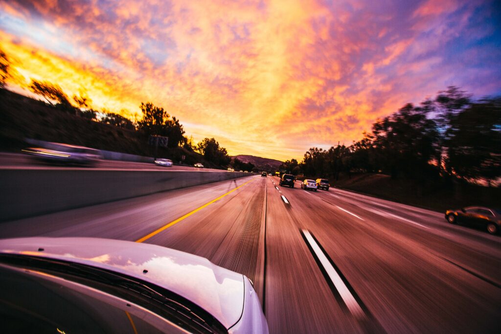 Car driving on highway into the sunset